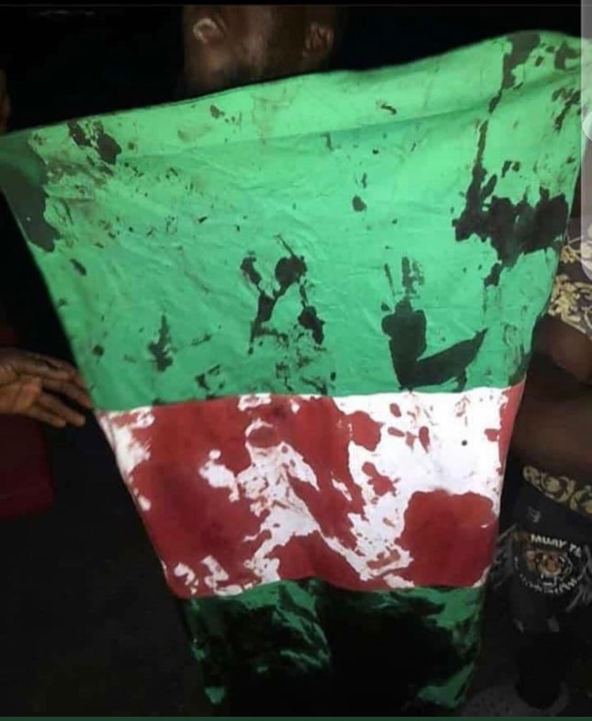 Nigerian flag stained with blood