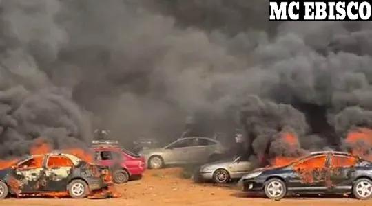 Cars burning with grey smoke filling the air